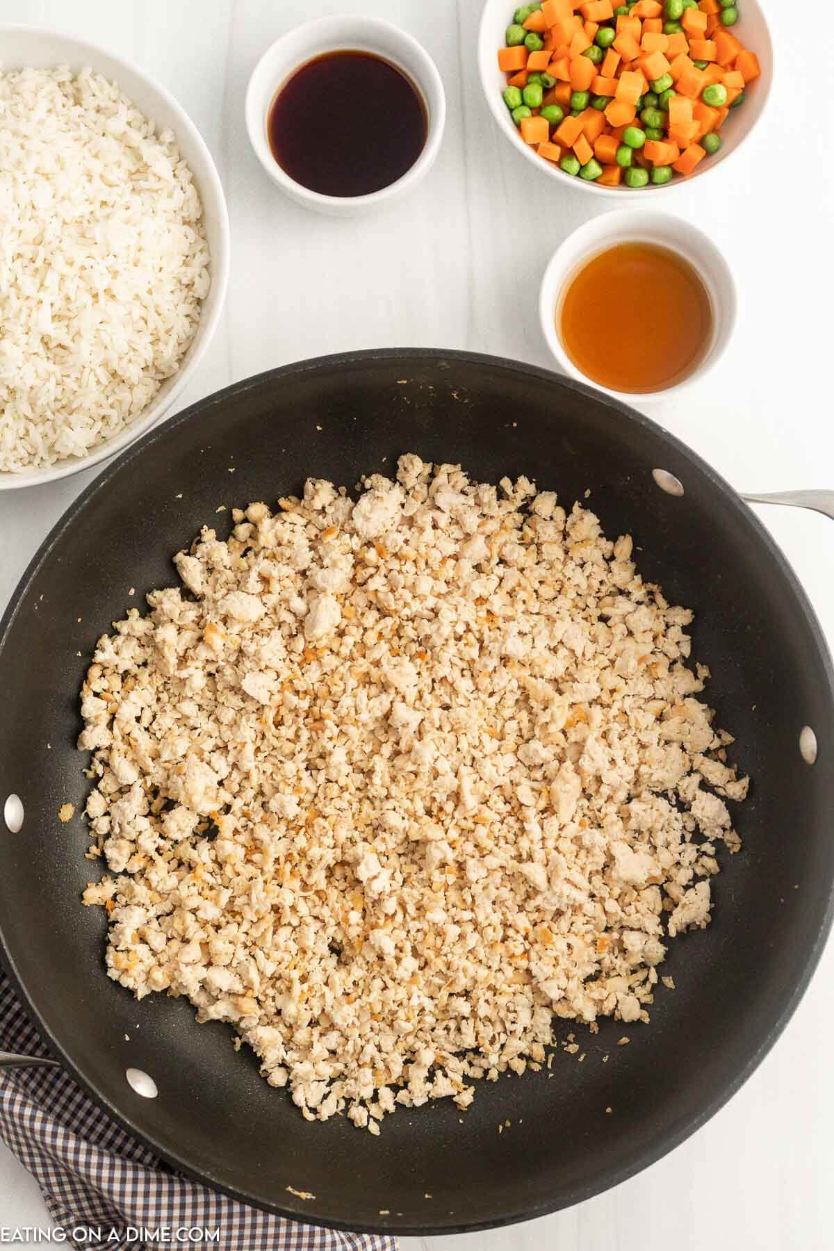 Ground chicken being cooked in skillet. 