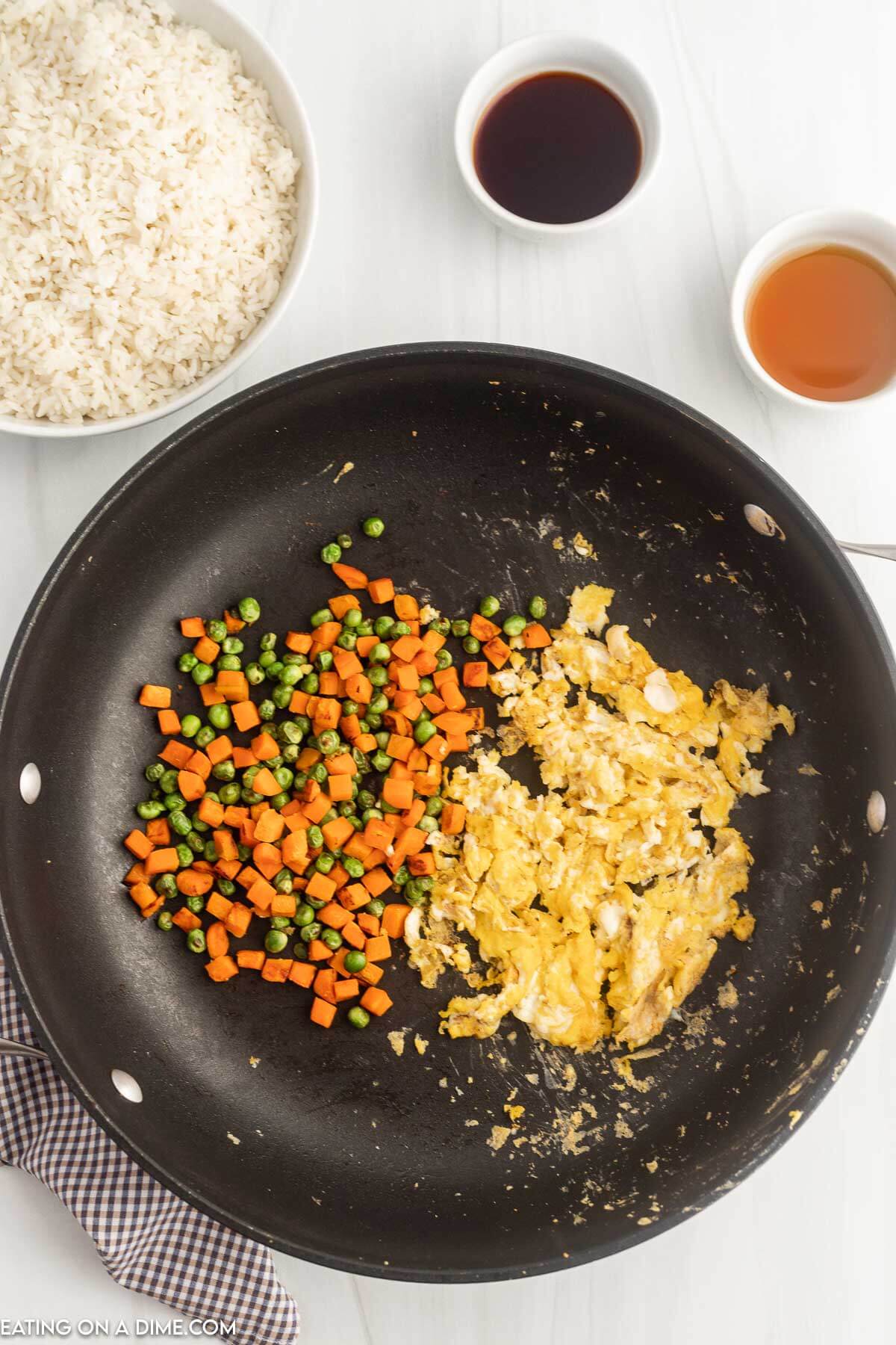 Scrambled eggs and veggies in skillet. 