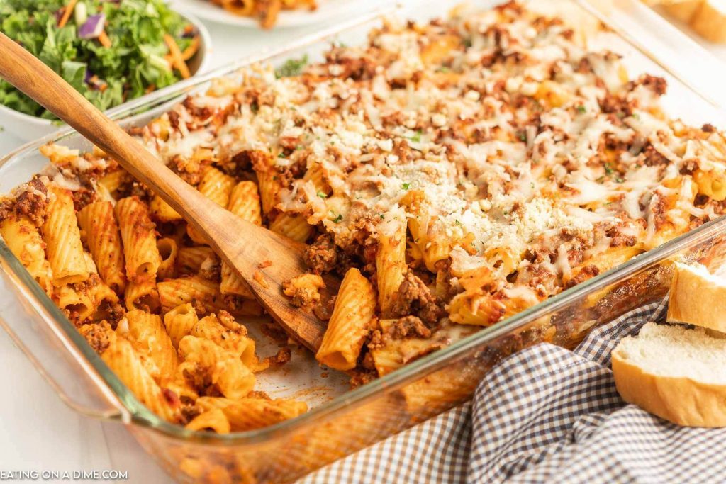 Easy pasta bake in a baking dish with a wooden spoon