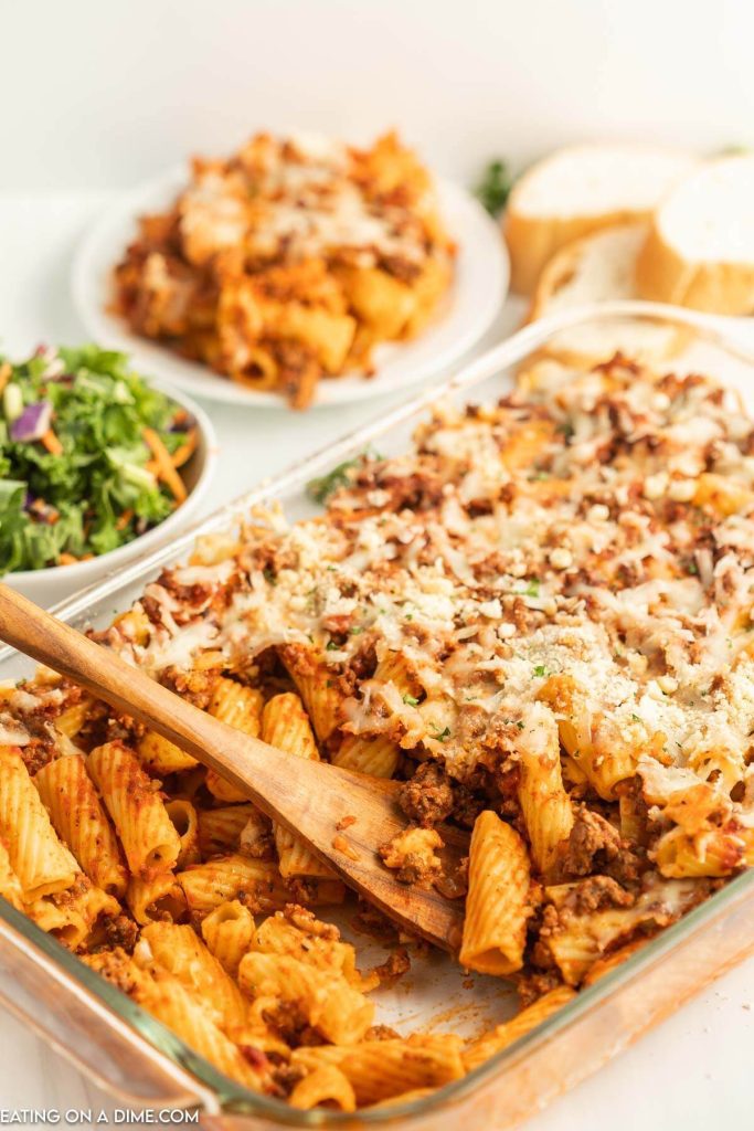 Easy pasta bake in a baking dish with a wooden spoon