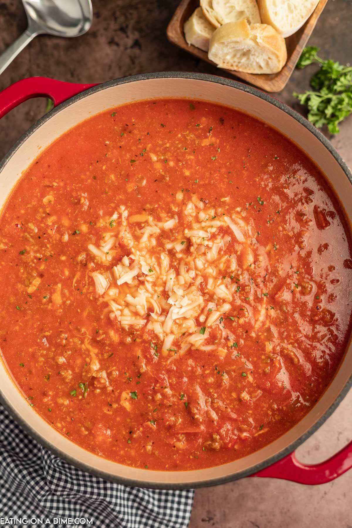 Pizza Soup in a dutch oven topped with cheese