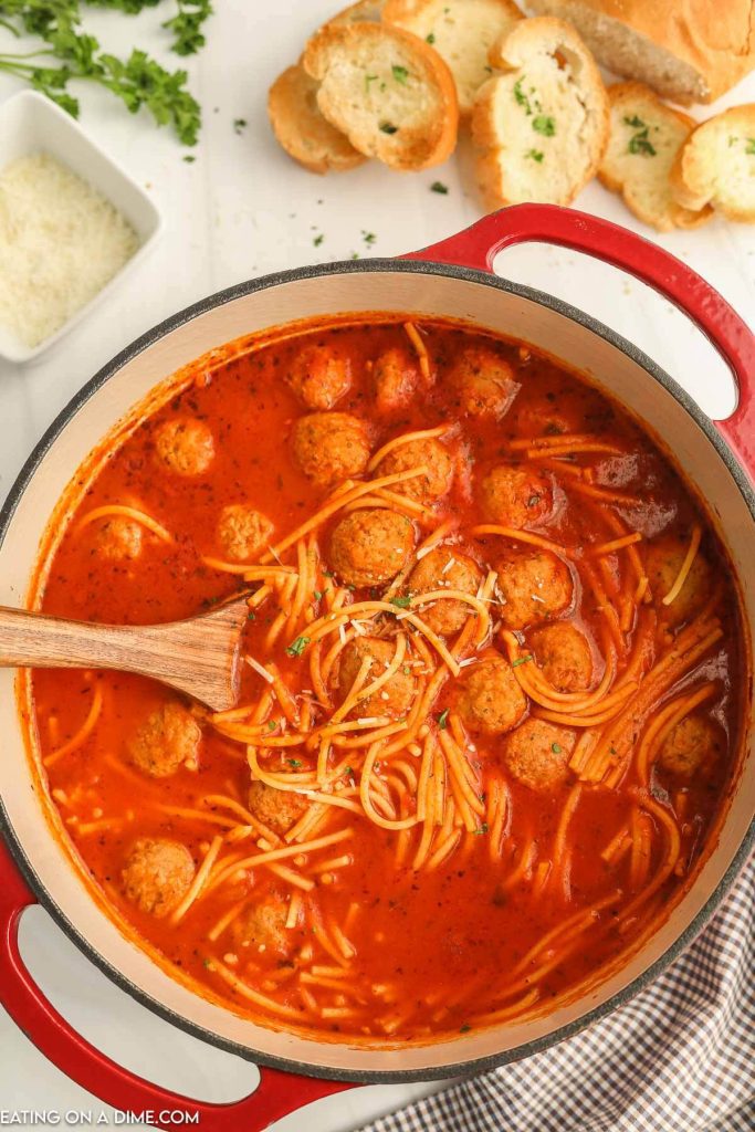 Spaghetti Soup in a large pot with a wooden spoon