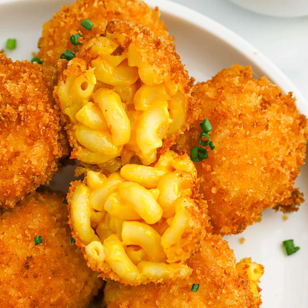 Fried Mac and Cheese Bals stacked on a plate