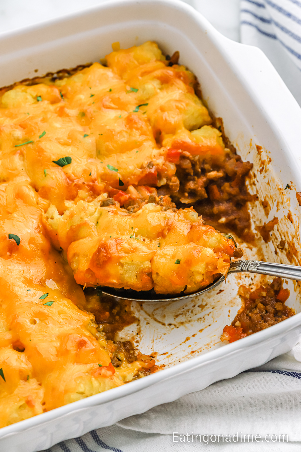 Sloppy Joe Tater Tot Casserole with a serving on a spoon