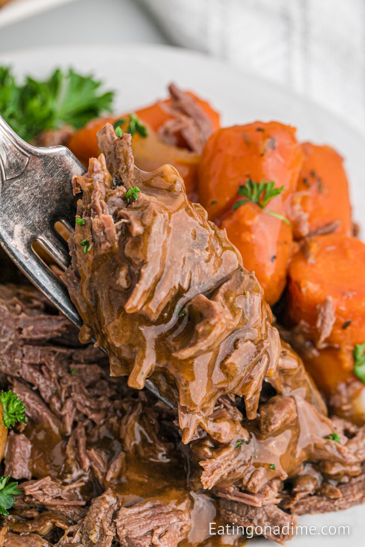 Venison Roast potatoes and carrots on a platter with a fork