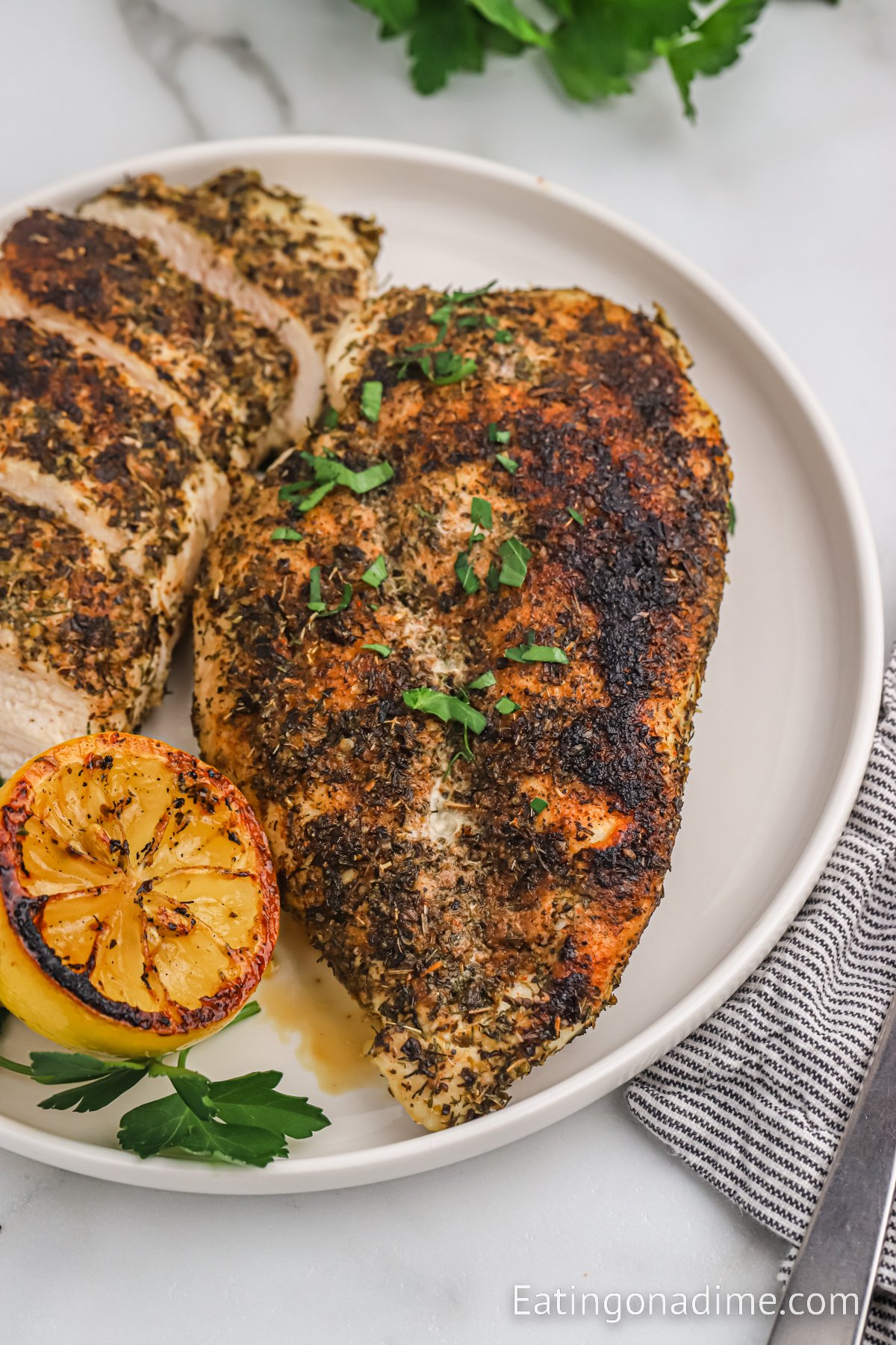 Herb Crusted Chicken sliced on a plate