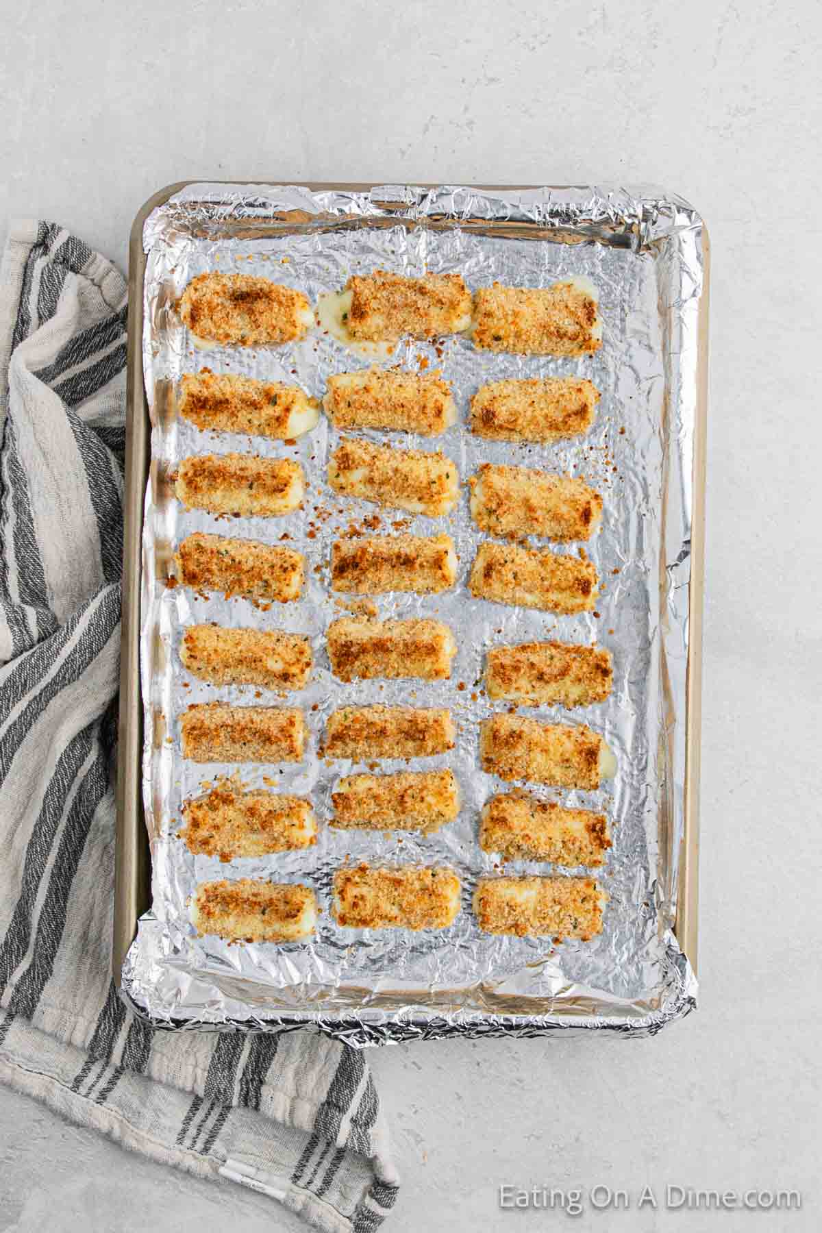 Baked cheese sticks on a baking sheet 