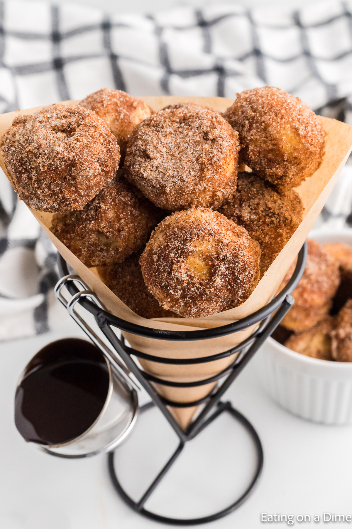 Cinnamon Sugar Donut Holes in a stand with a side of dipping sauce