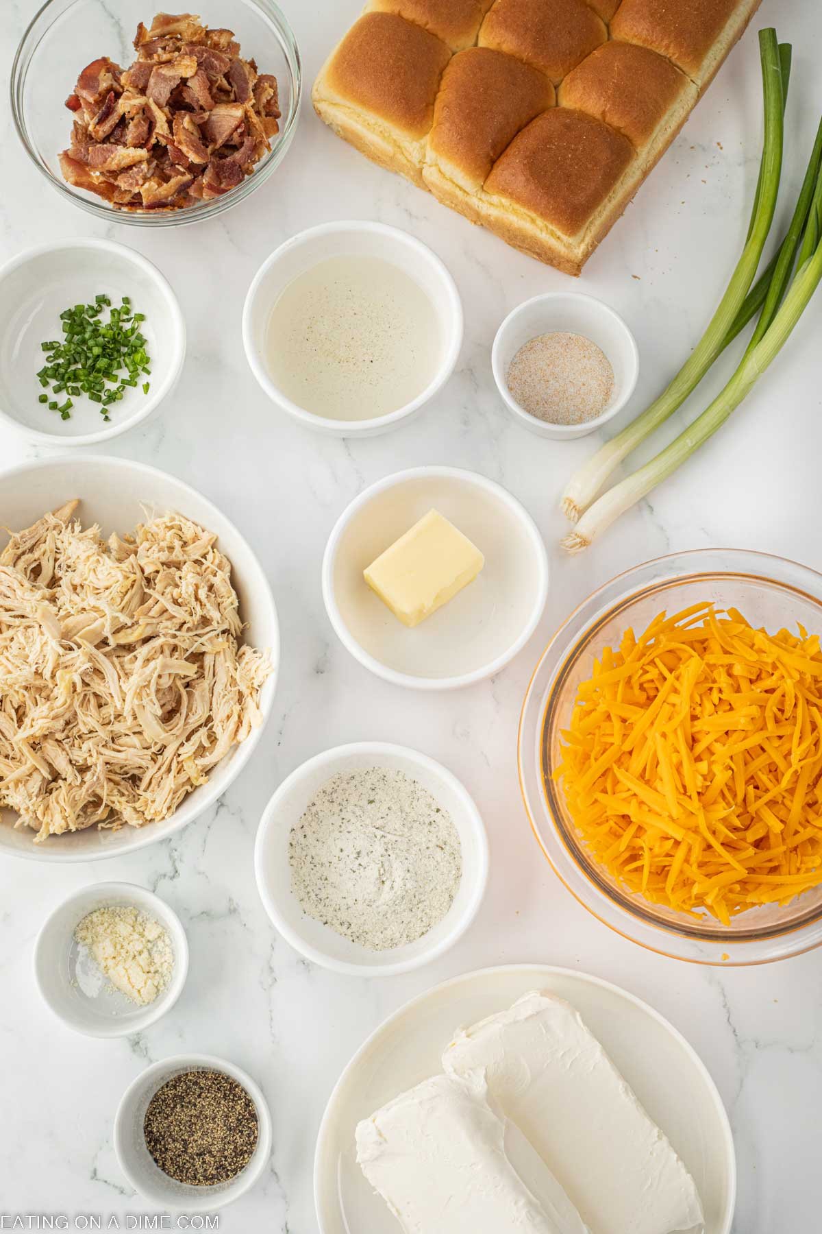 Ingredients needed - chicken breast, cream cheese, ranch dressing mix, black pepper, bacon, chicken broth, cheddar cheese, green onions, hawaiian rolls, butter, garlic salt, parmesan cheese, chives
