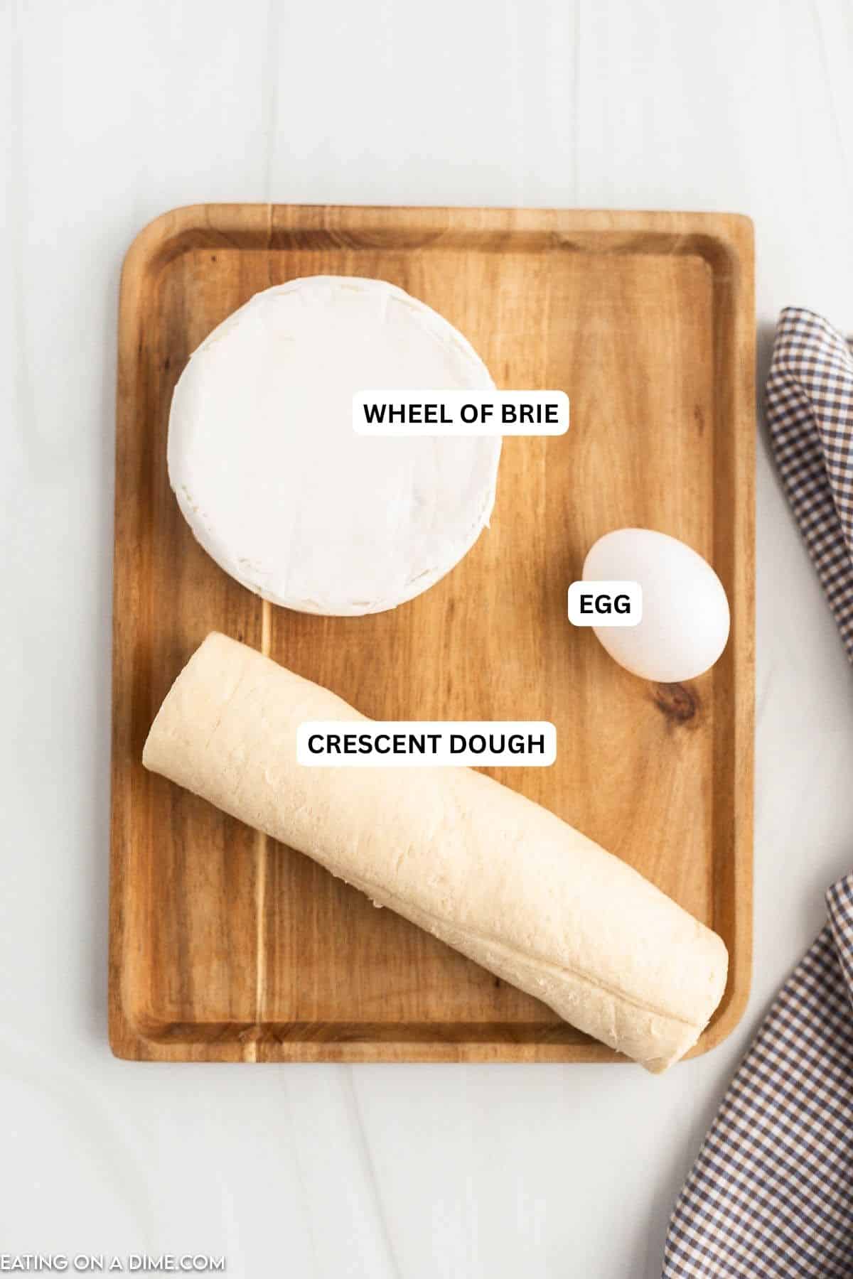Ingredients for recipe: wheel of brie, egg and crescent roll dough.