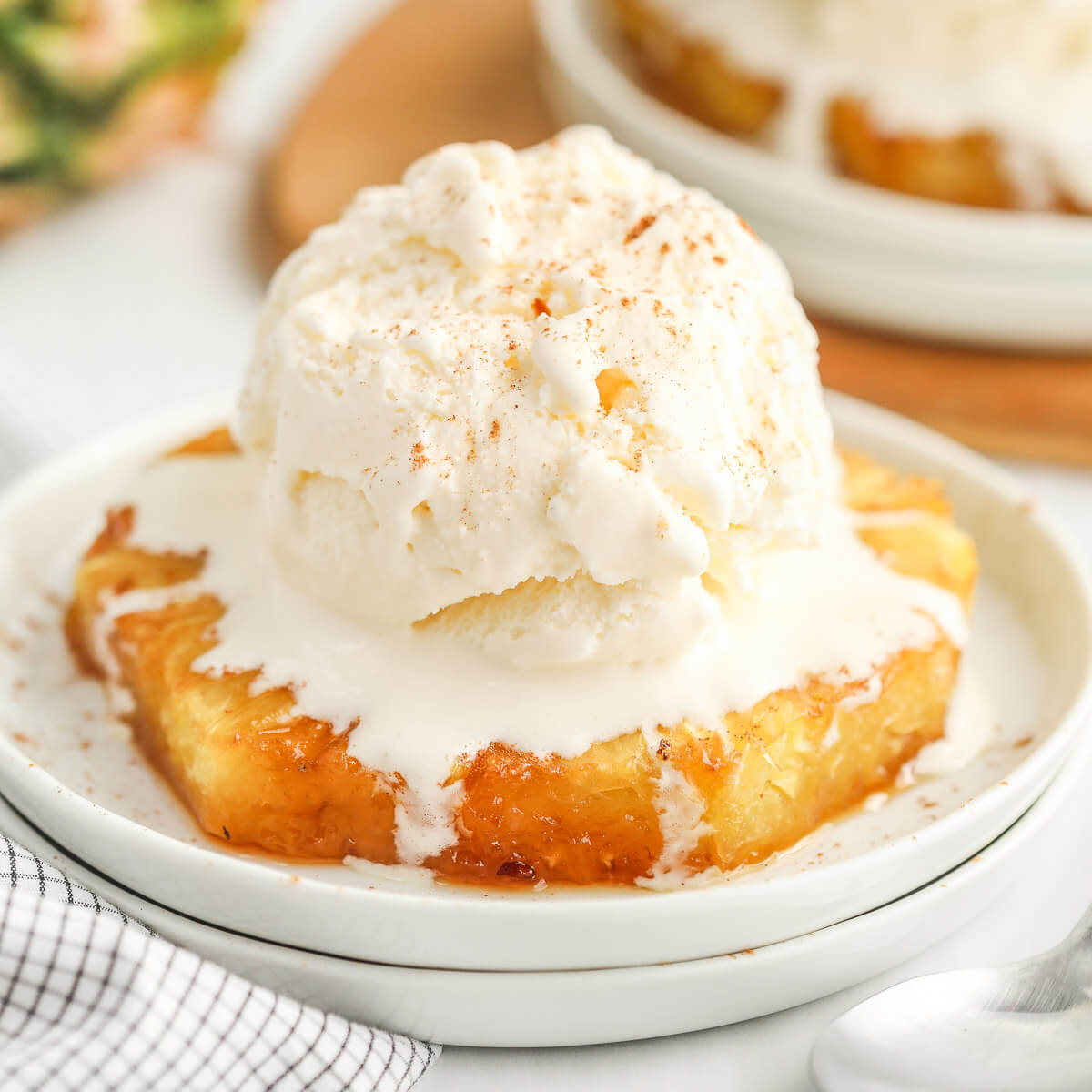 Baked Pineapple on a plate with a scoop of ice cream