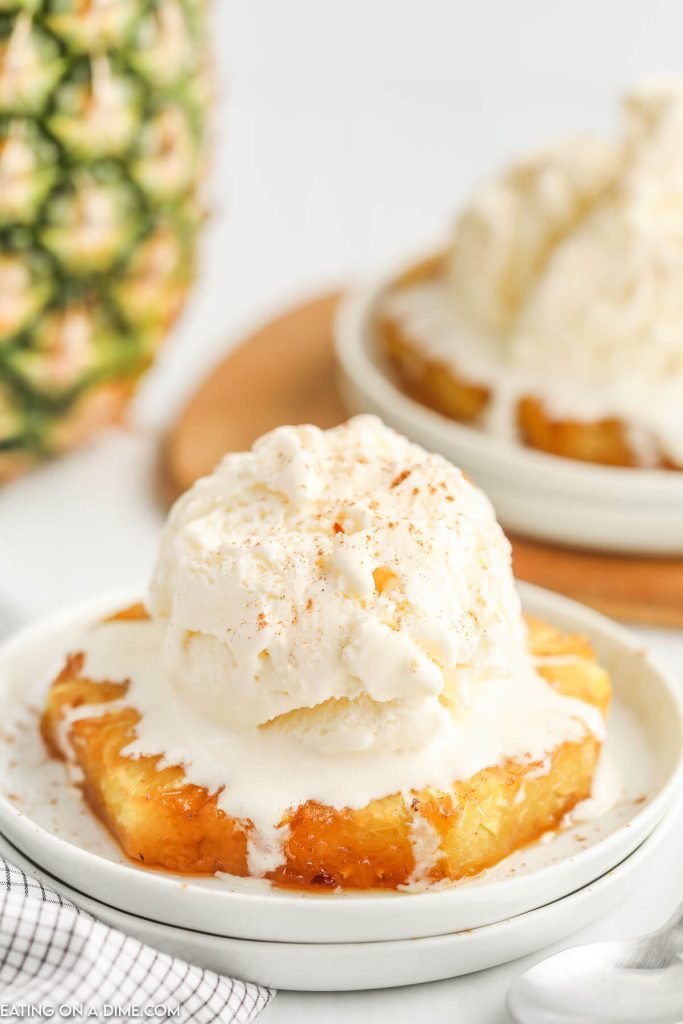 Baked Pineapple on a plate with a scoop of ice cream