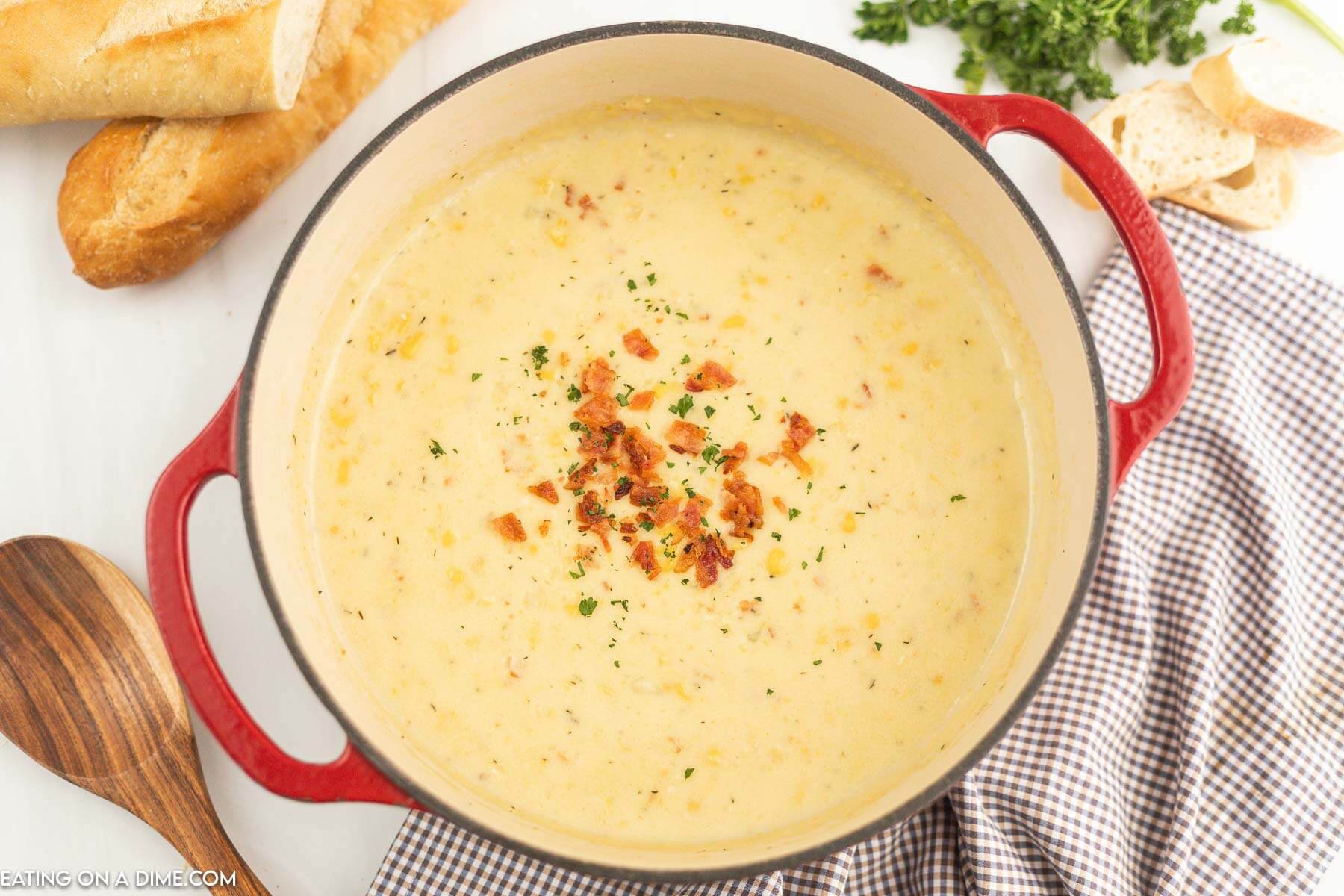 Corn Chowder in a dutch oven topped with chopped bacon