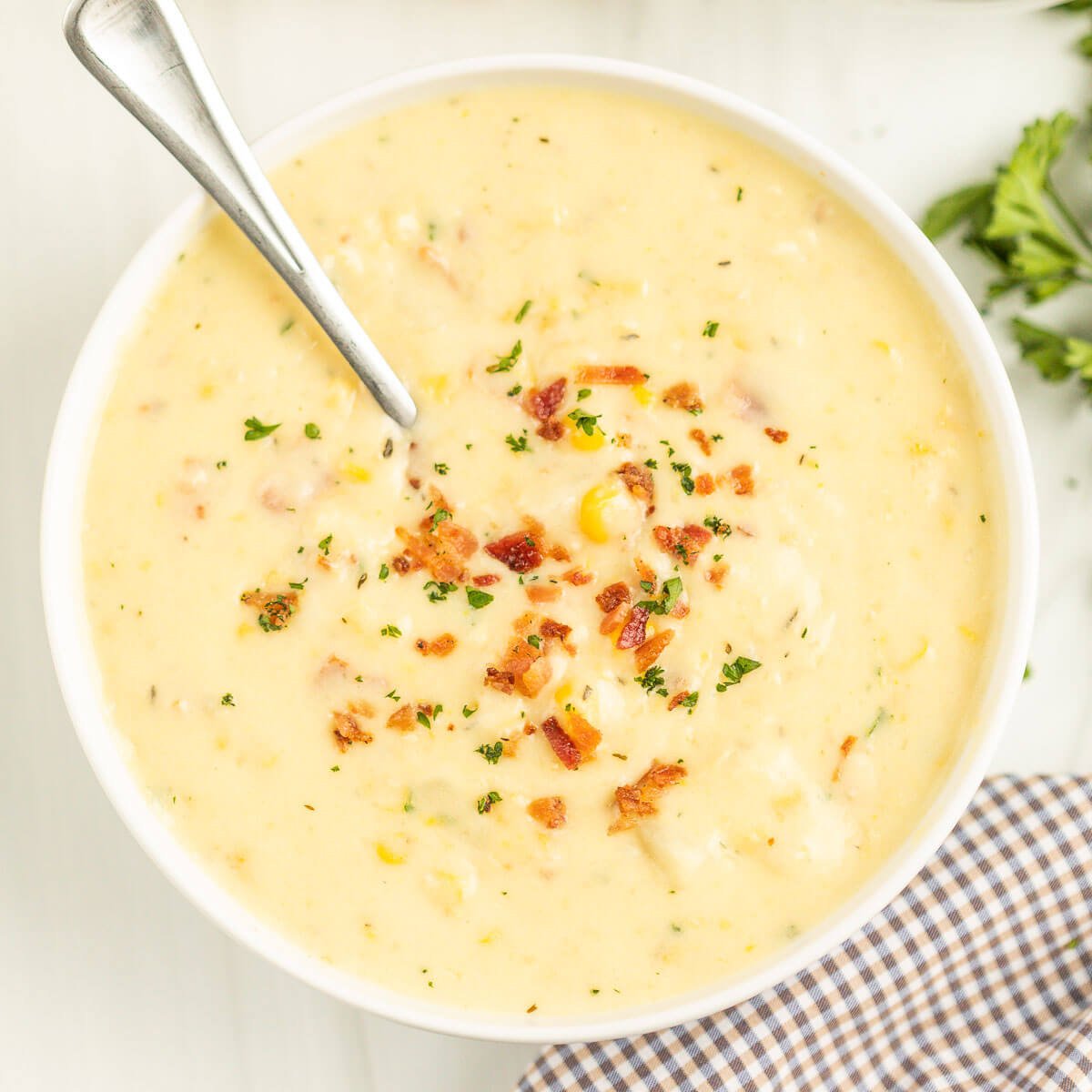 Corn Chowder in a white bowl with a spoon