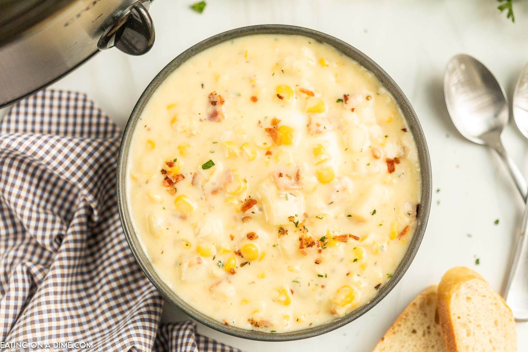 Corn Chowder in a black bowl with a spoon