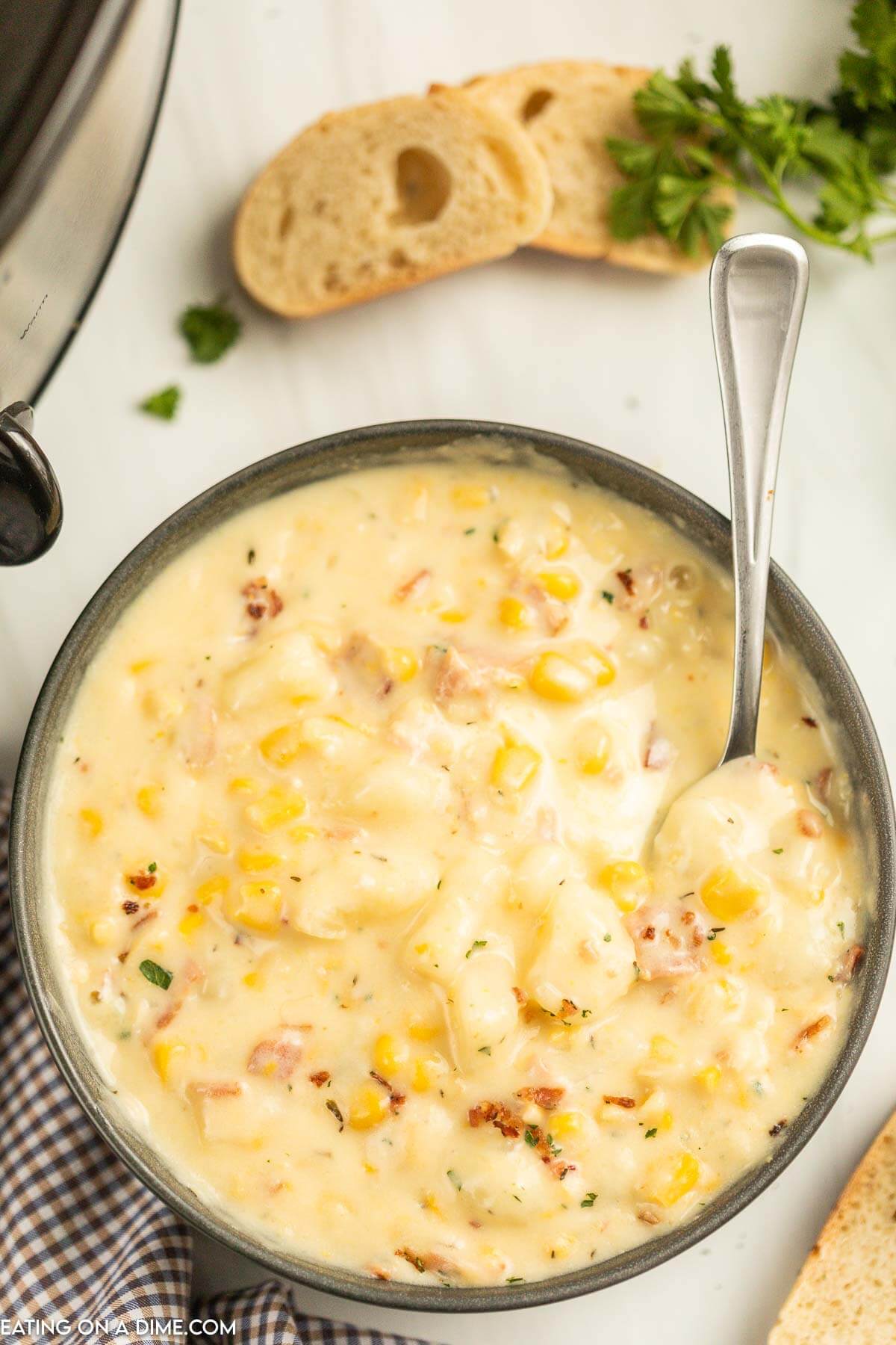 Corn Chowder in a black bowl with a spoon