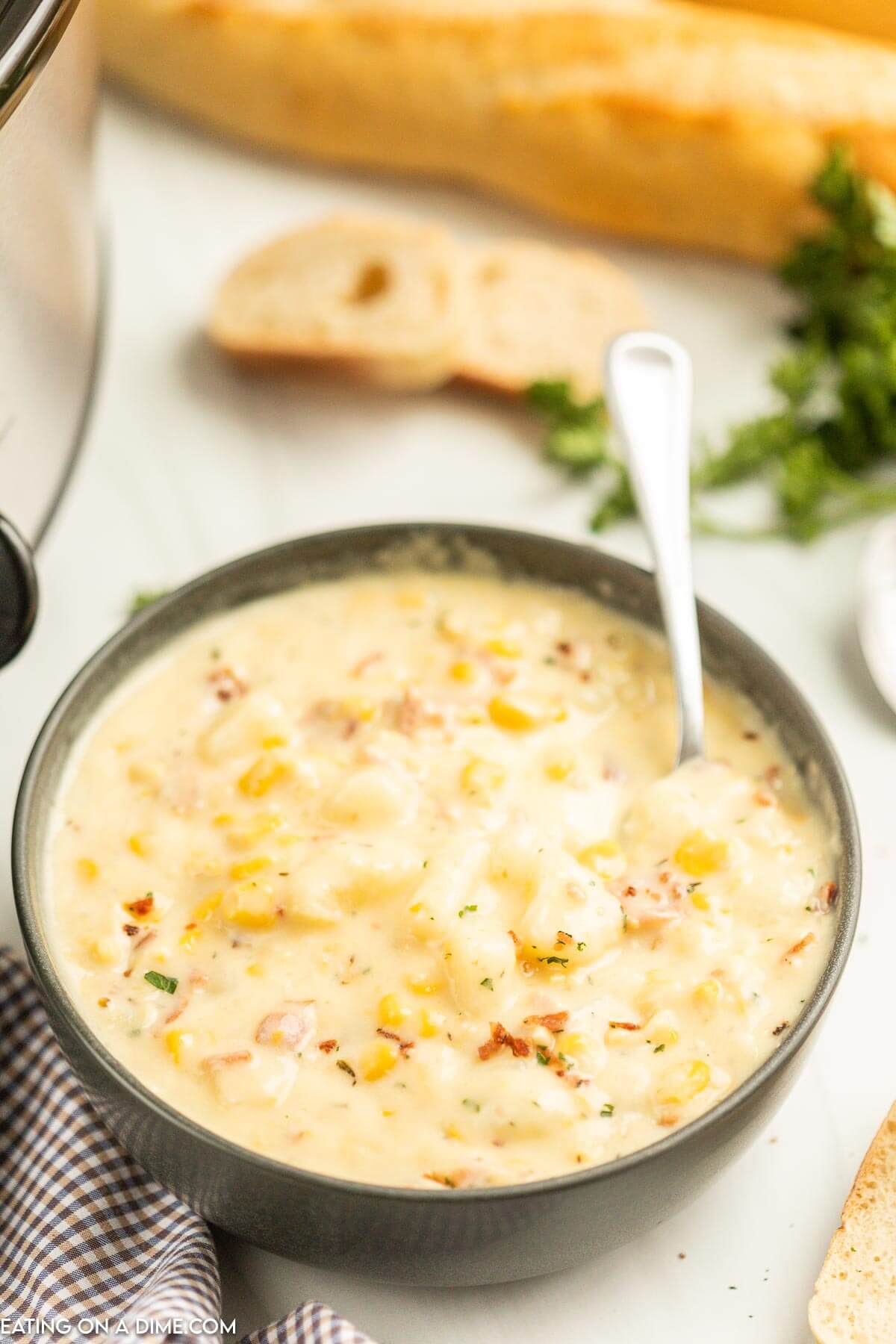 Corn Chowder in a black bowl with a spoon