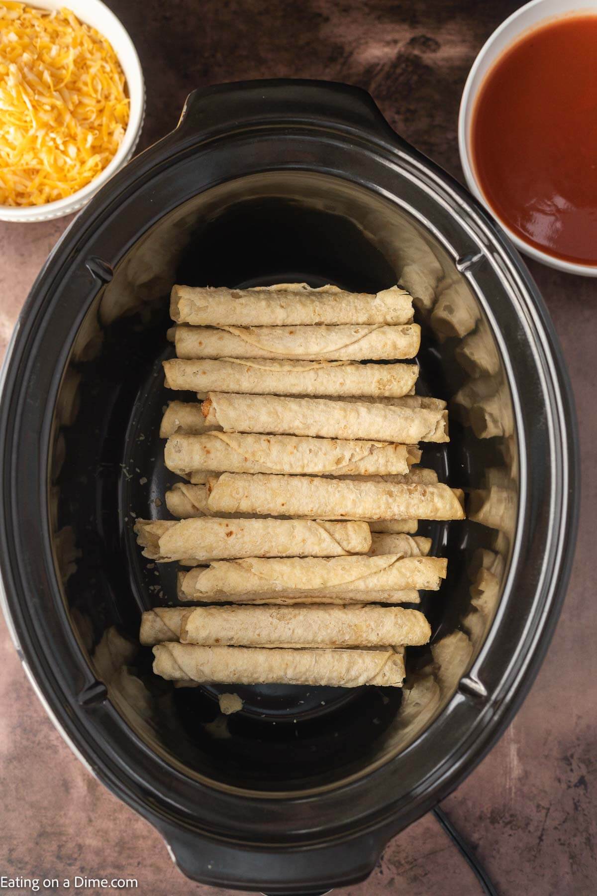Placing taquitos in the slow cooker