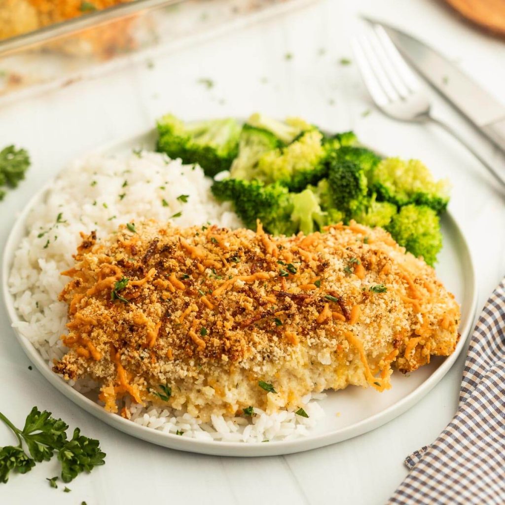 Baked Ranch Chicken on a white plate with rice and broccoli