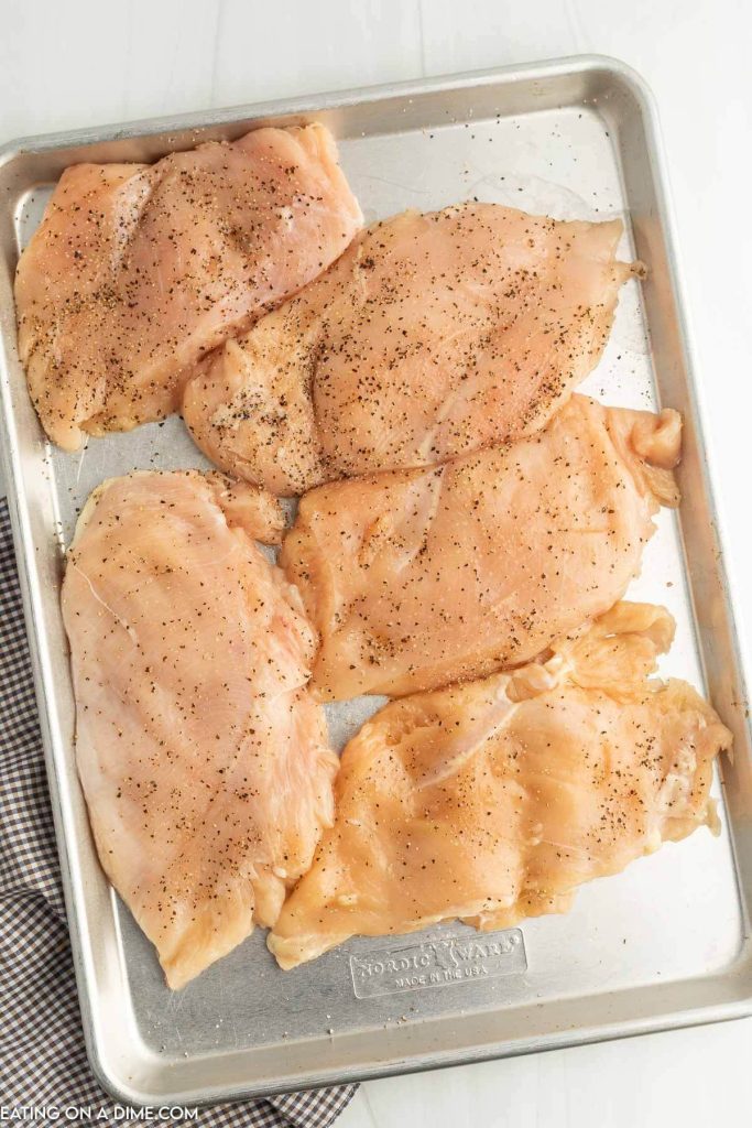 Pounded chicken breast on a baking sheet