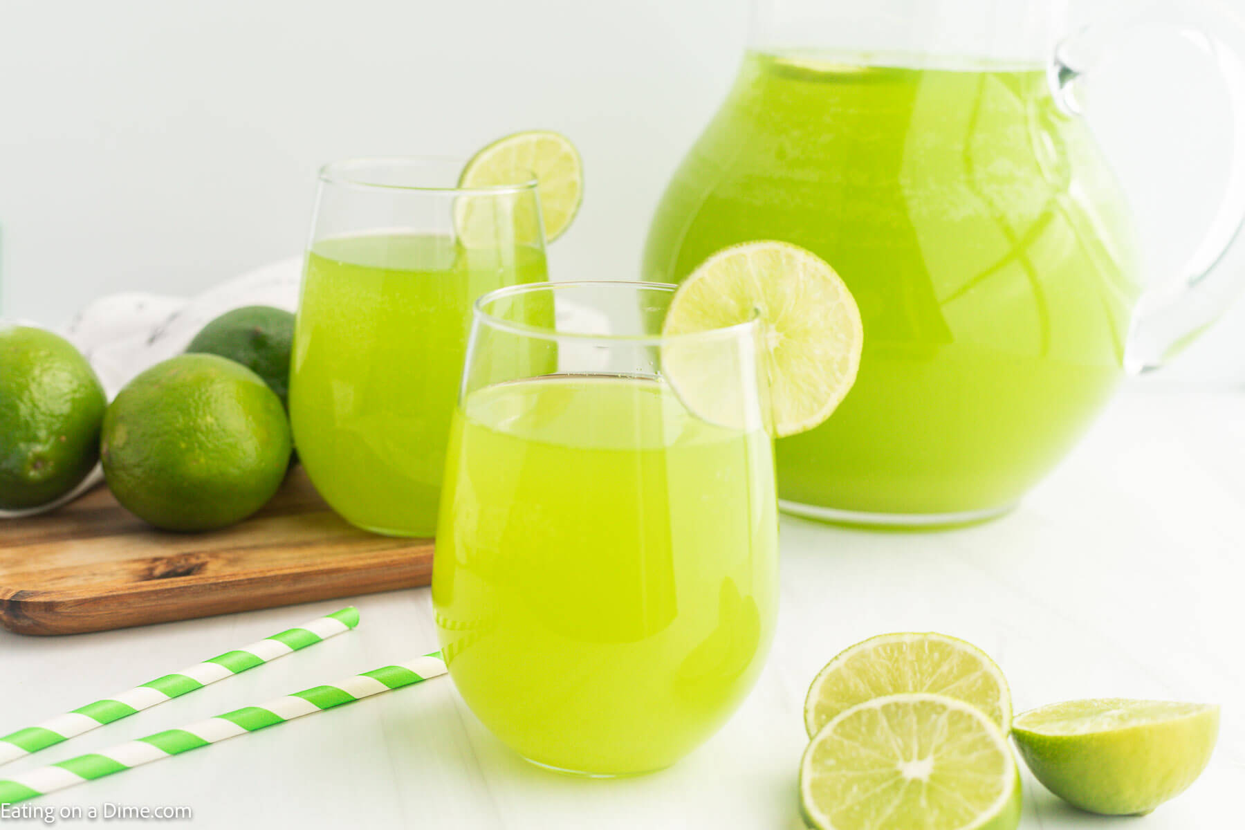 Green Punch in a glass with a lime wedge on the side of the glass