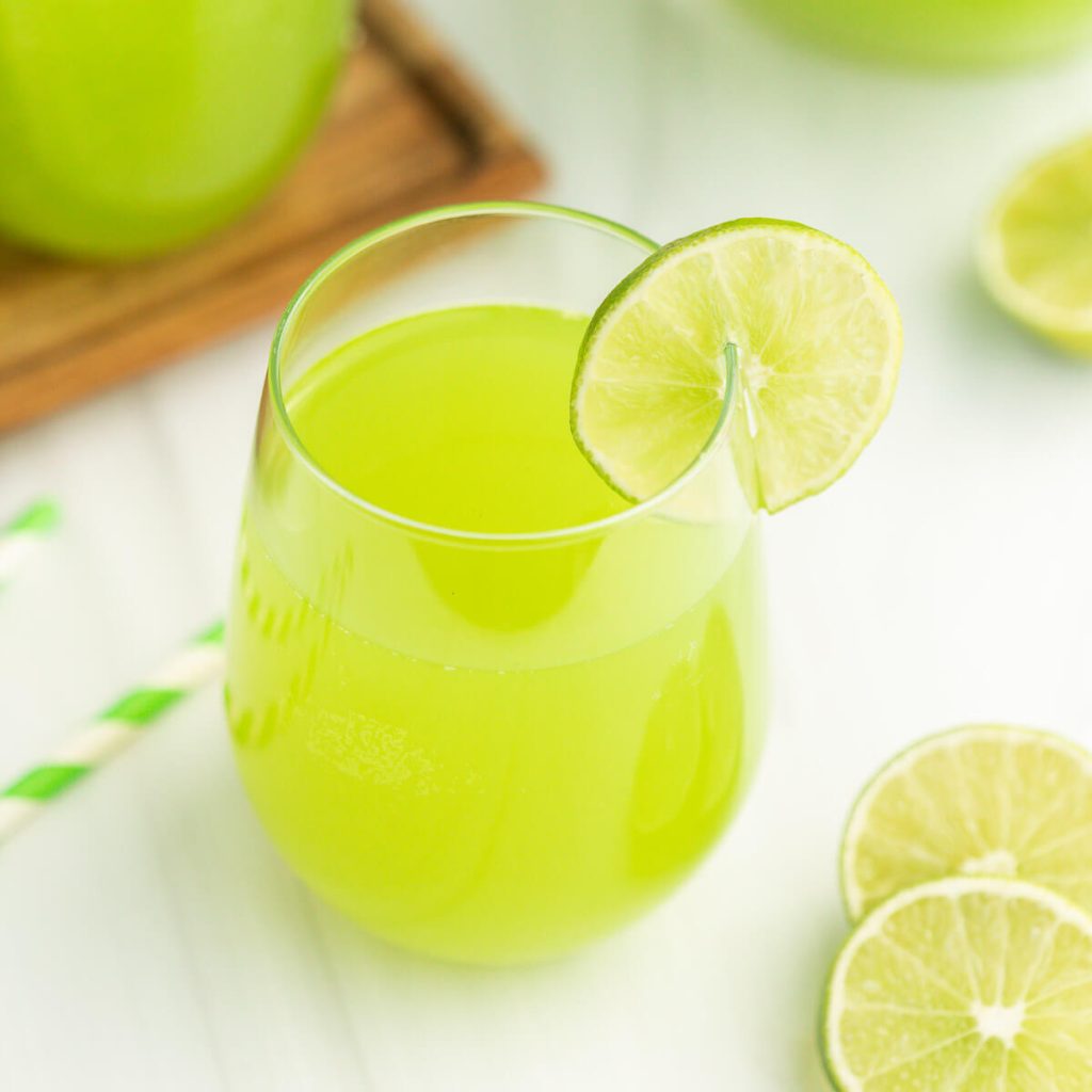 Punch in a glass with a lime wedge on the side of the glass