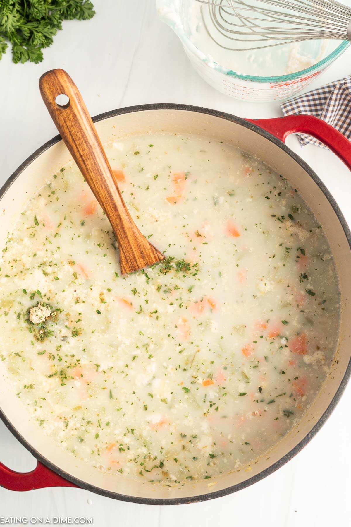 Panera Chicken and Wild Rice soup in a Dutch Oven Pot with a wooden spoon