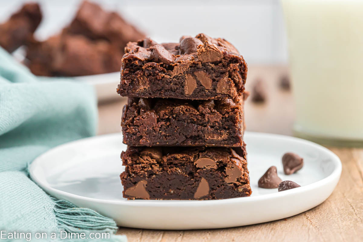 Brownie squares stacked on a plate