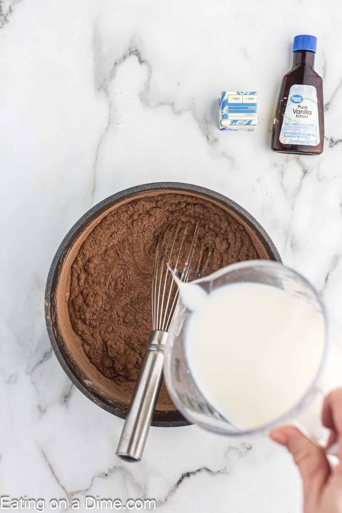 Pouring the milk into the dry ingredients in the sauce pan