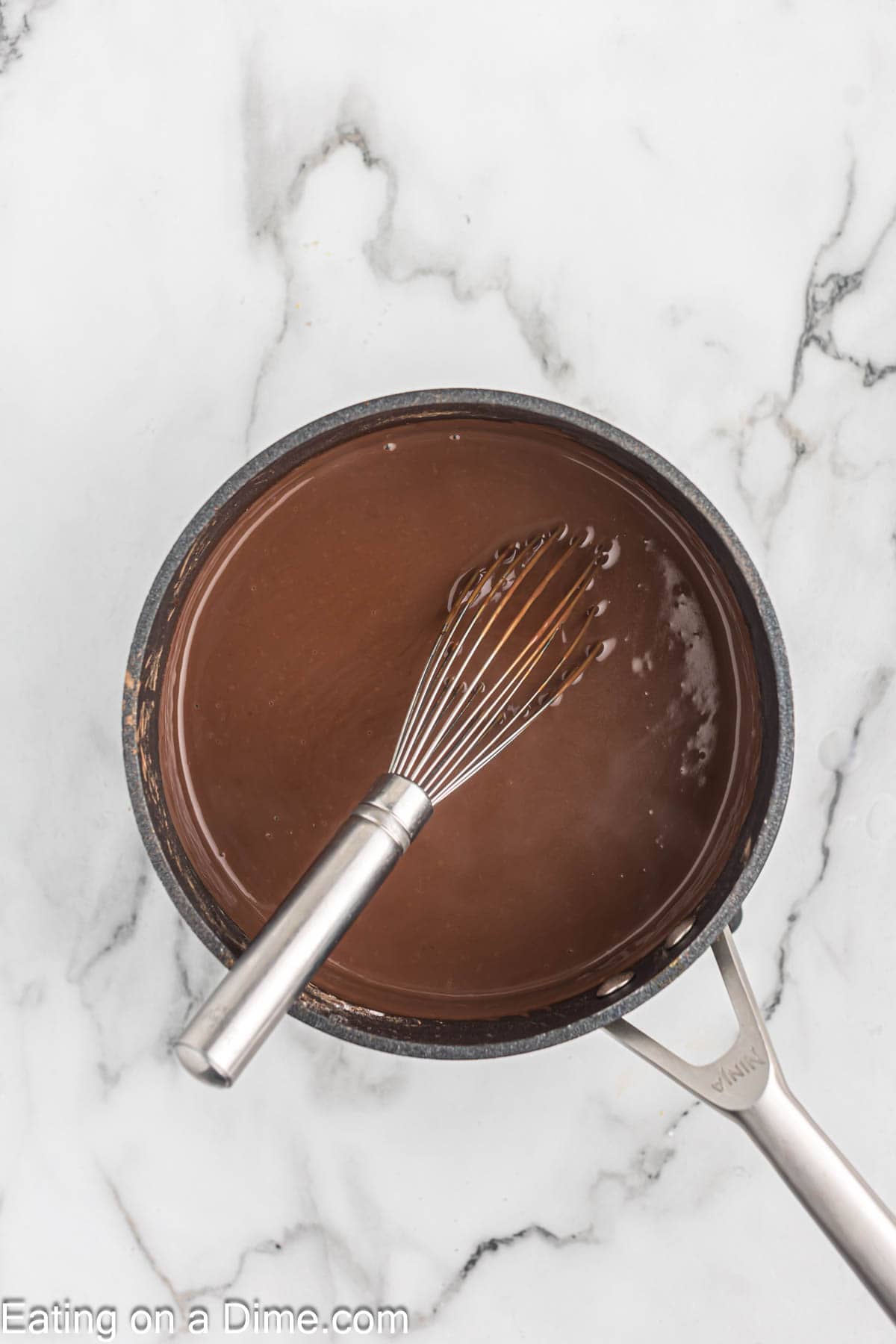 Whisking the chocolate pudding in a sauce pan