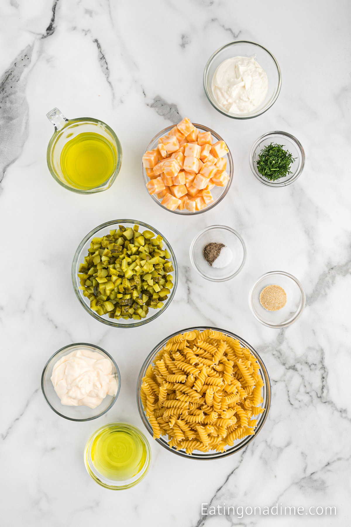 Ingredients needed - rotini pasta, dill pickle juice, baby dill pickles, cheese, mayonnaise, sour cream, dried dill, salt and pepper onion powder