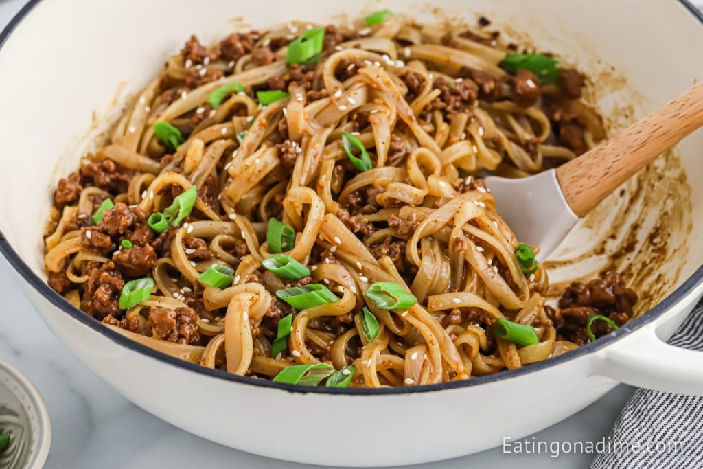 Mongolian Beef and Noodle in a large pot with a spoon