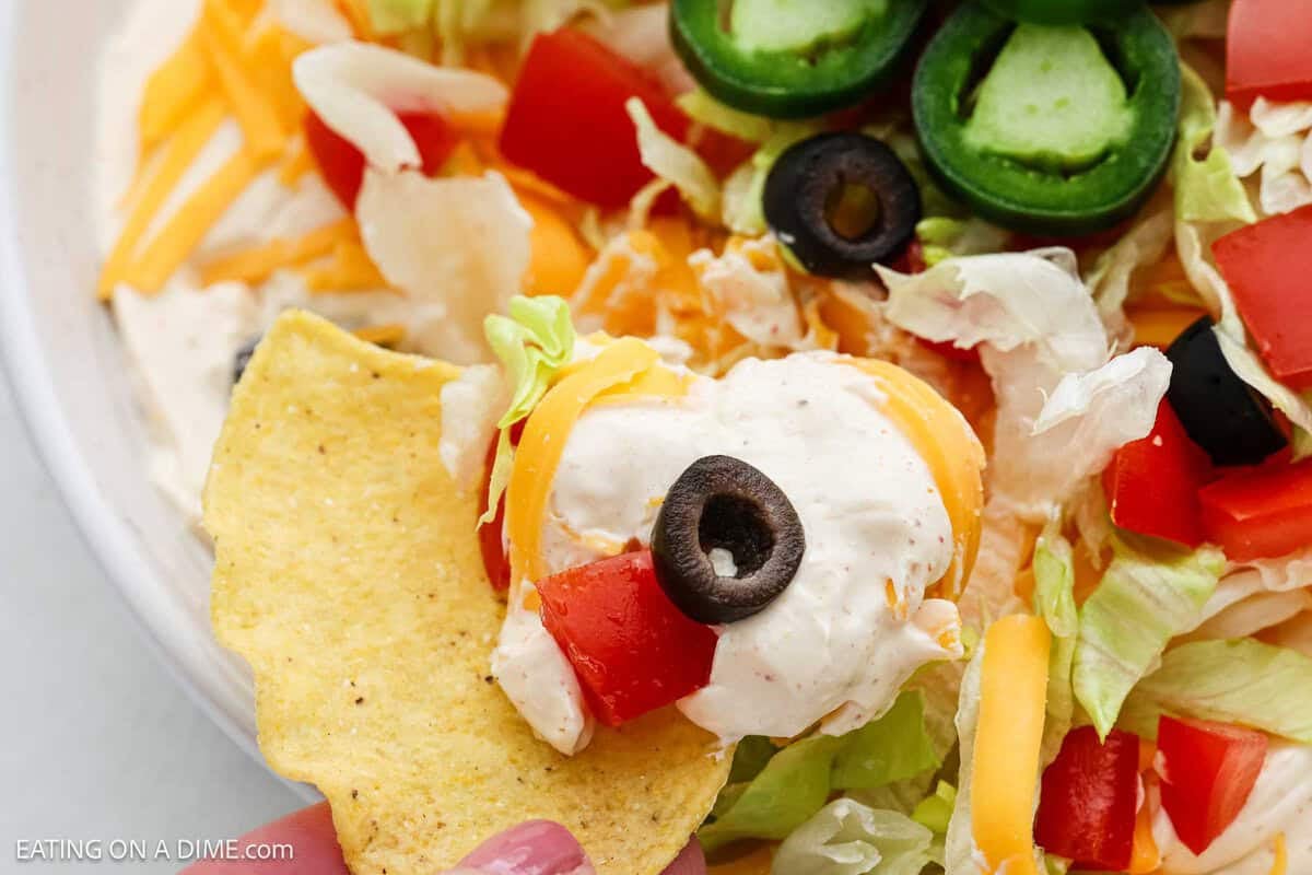 Serving the taco dip with a tortilla chips