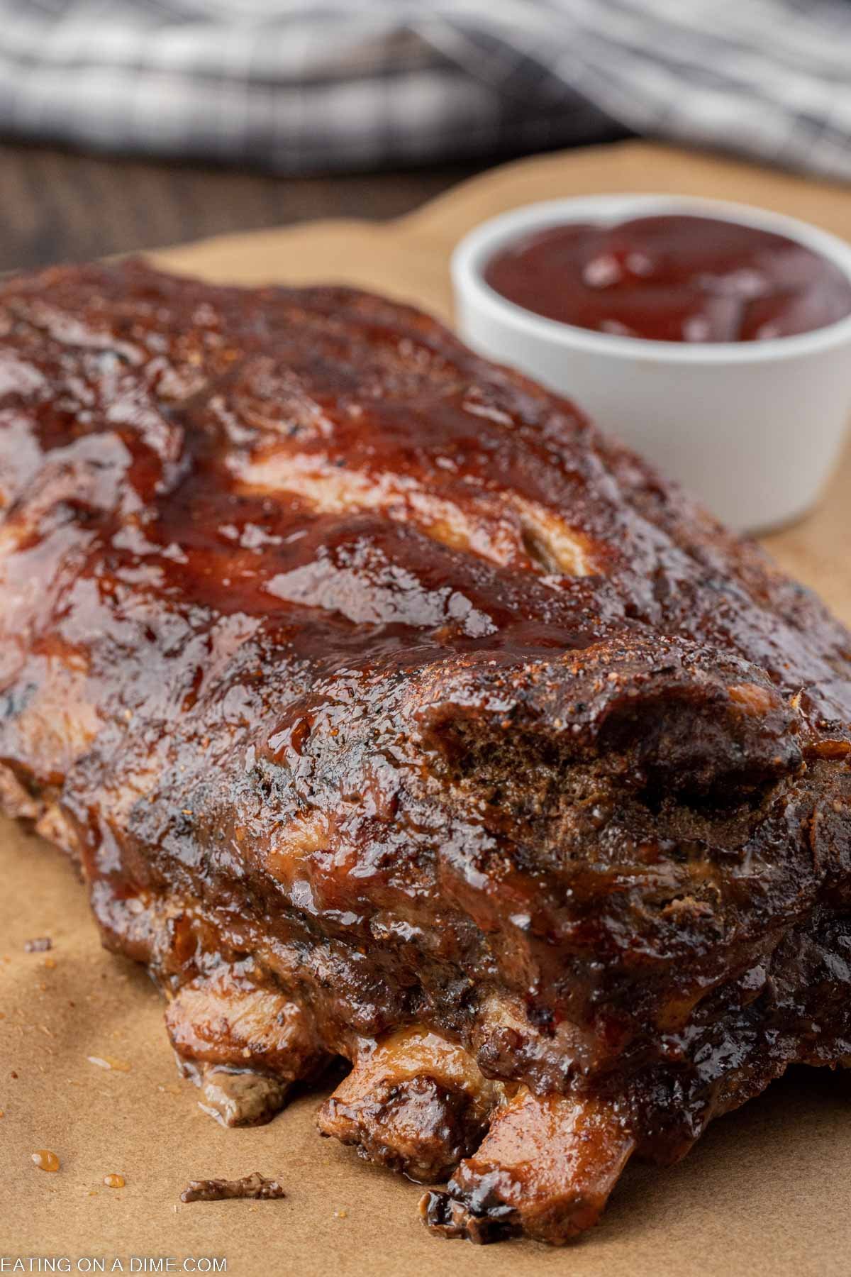 Baby Back Ribs on a platter with a side of BBQ Sauce