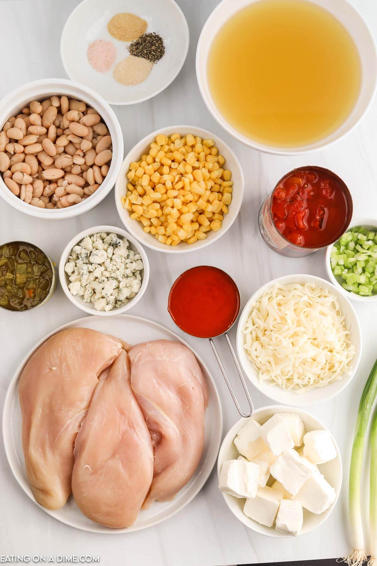 Ingredients needed - chicken breast, chicken broth, fire roasted diced tomatoes, green chiles, wing sauce, corn, celery, onion powder, pepper, salt, cream cheese, monterey jack cheese, blue cheese crumbles, green onions