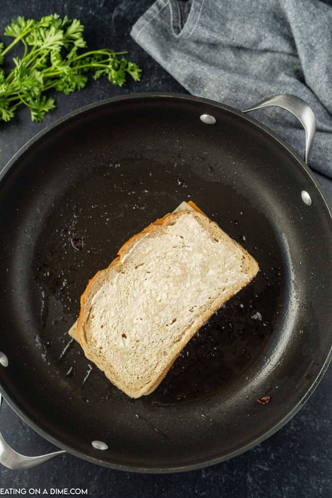 Cooking the grilled cheese sandwich in a skillet