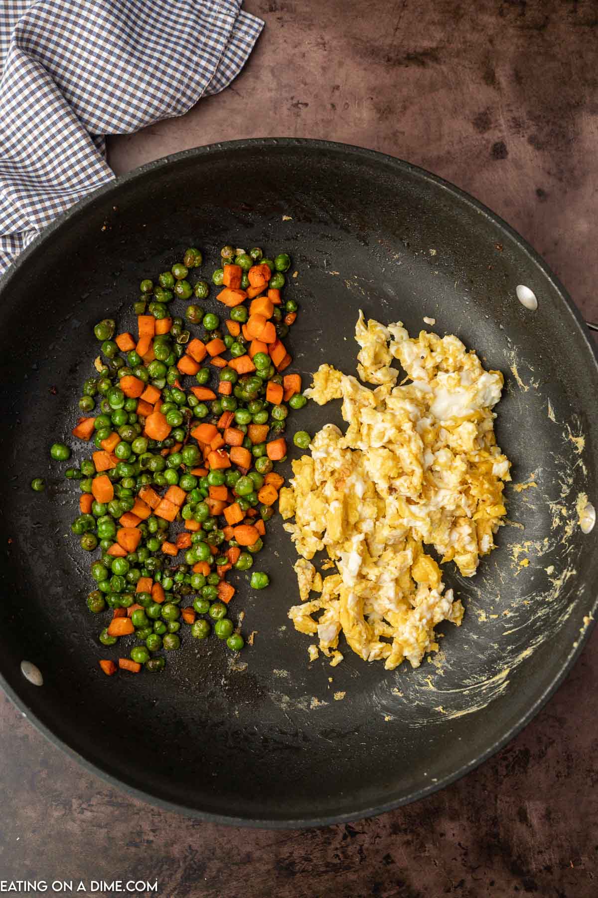 Cooking the frozen veggies and scrambling the egg