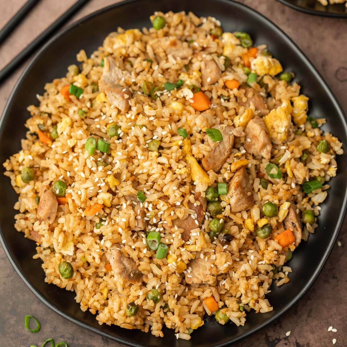 Pork Fried Rice on a plate with chopsticks