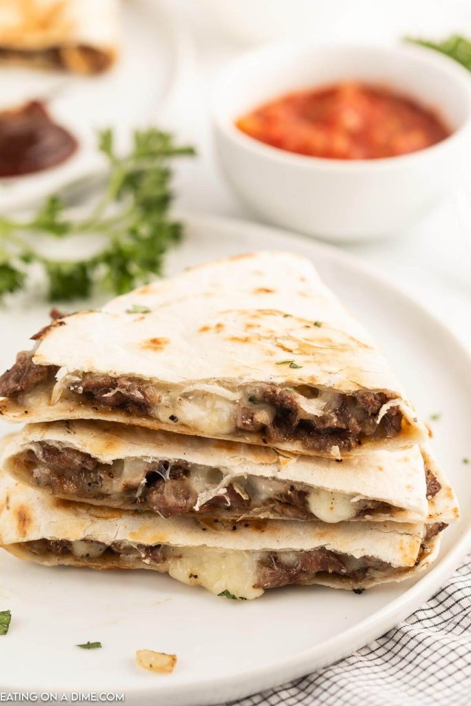 Steak and cheese quesadilla sliced with salsa