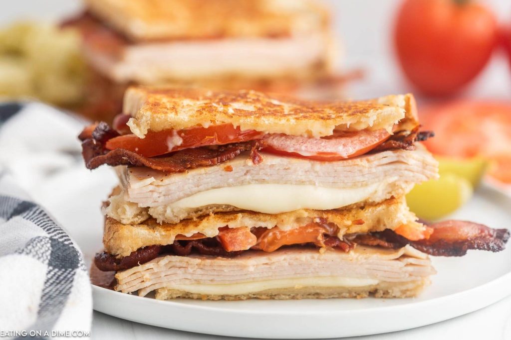 Turkey Melt Sandwich cut in half and stacked on a plate