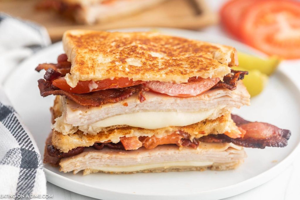 Turkey Melt Sandwich cut in half and stacked on a plate