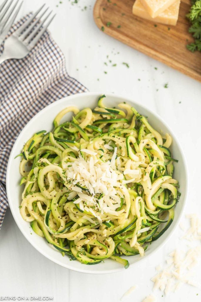 Zucchini Noodles topped with mozzarella cheese in a white bowl