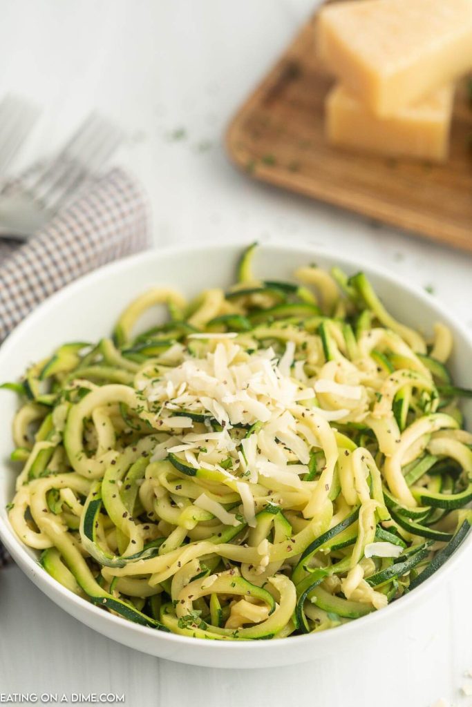 Zucchini Noodles topped with mozzarella cheese in a white bowl