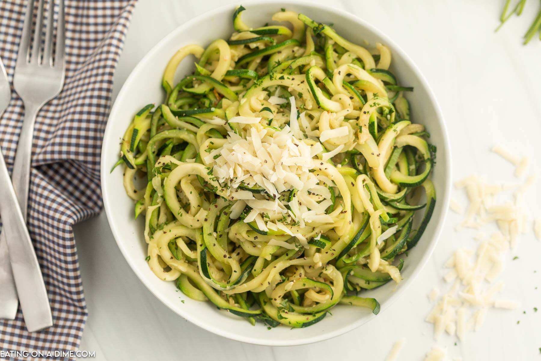 Zucchini Noodles topped with mozzarella cheese in a white bowl