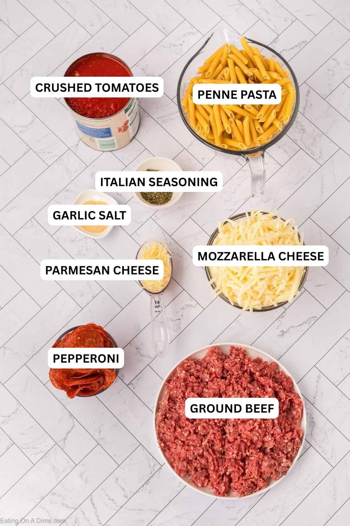 Ingredients for recipe: crushed tomatoes, penne pasta, Italian Seasoning, garlic salt, mozzarella cheese, parmesan cheese, pepperoni and ground beef.