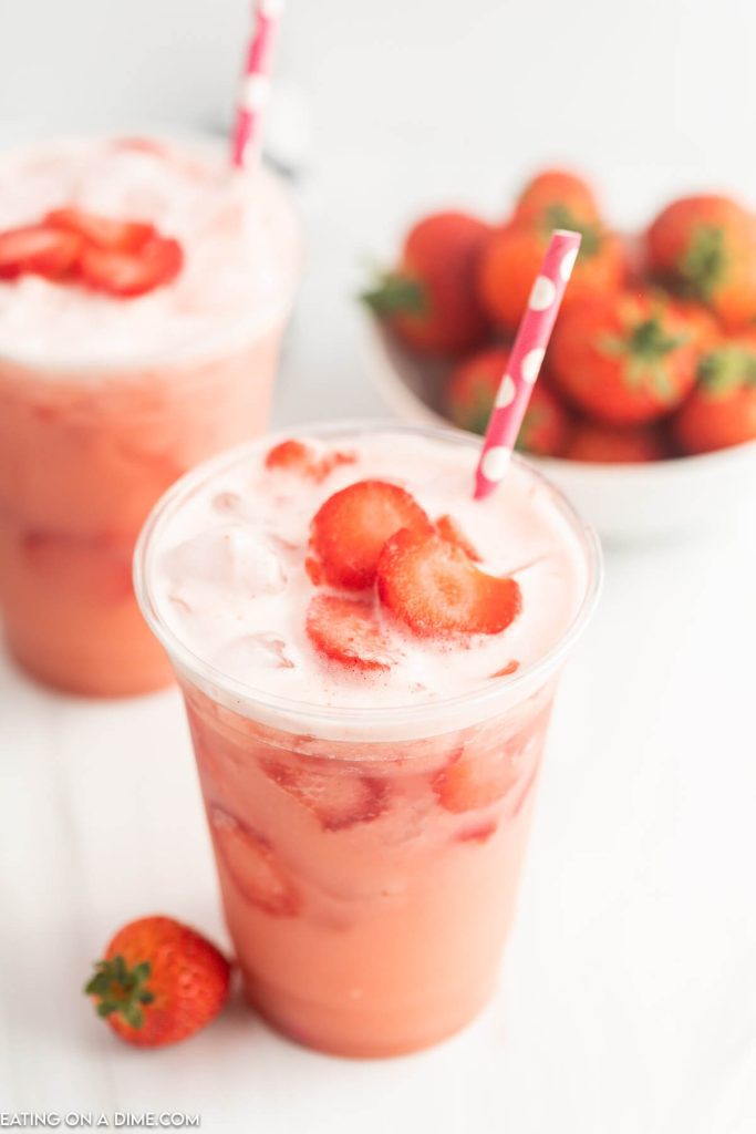 Starbucks Pink Drink in a cup with slice strawberries