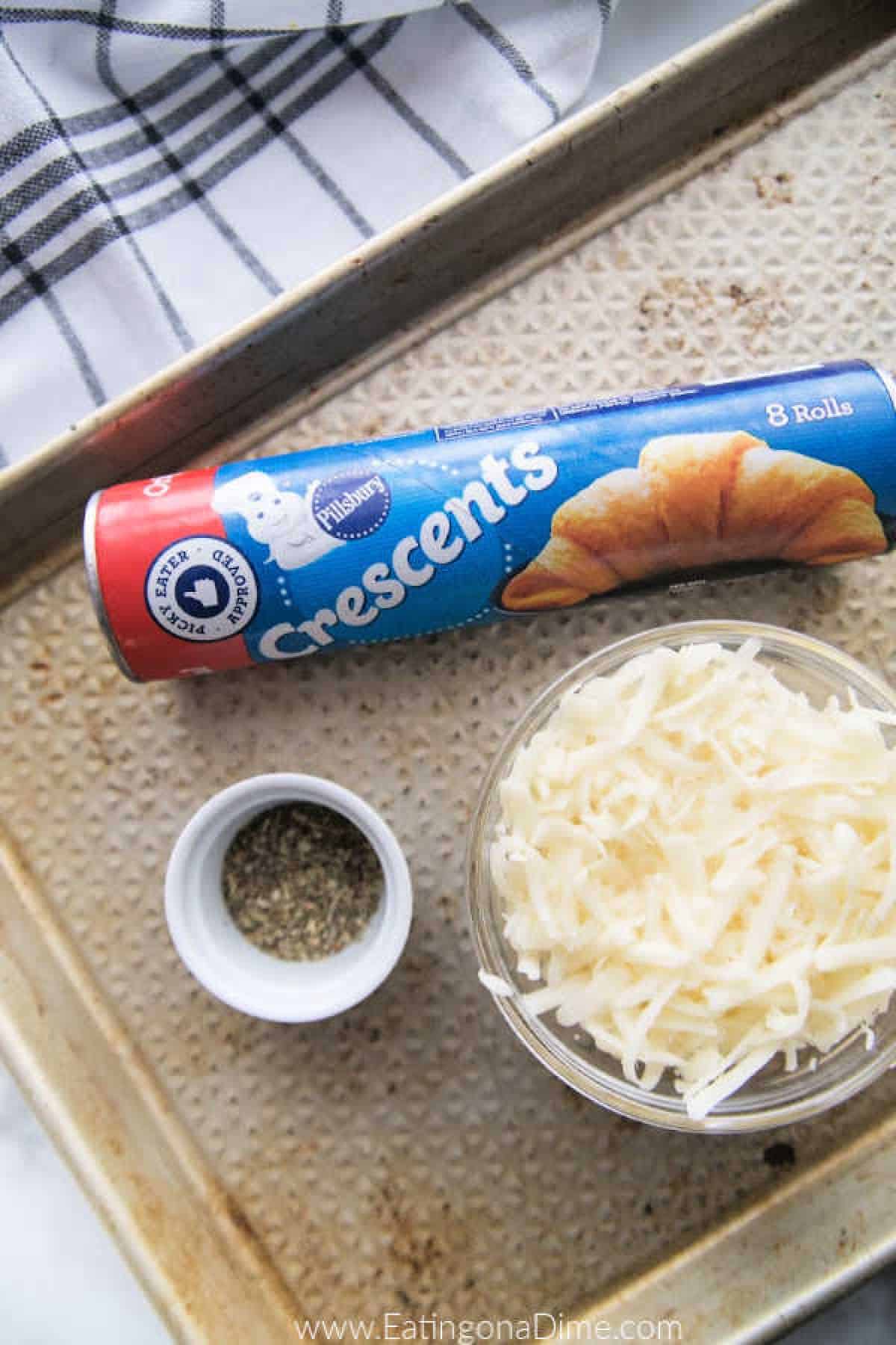 You just have to make this Stuffed Cheesy Bread Recipe with crescent rolls. This is the best cheesy bread and it only takes 15 minutes to make! Try this easy bread recipe. #eatingonadime #appetizerrecipes #breadrecipes Ingredients needed - crescent rolls, mozzarella cheese, italian seasoning, parmesan cheese