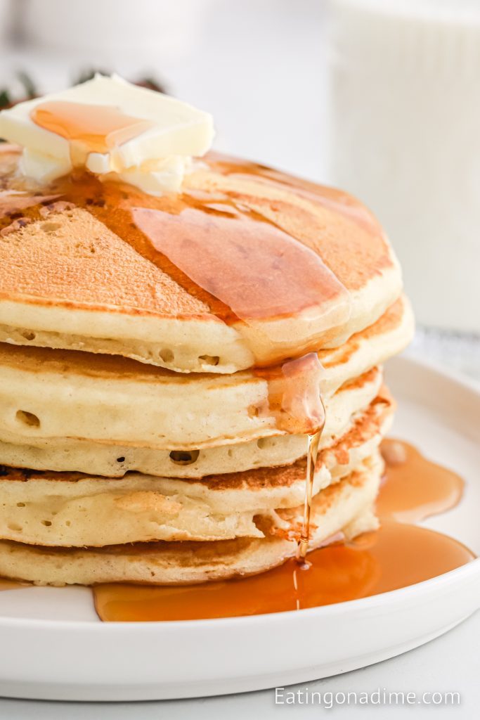 Stack of pancakes on a plate with syrup 