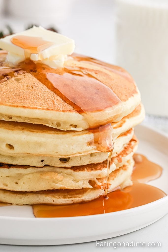 Stack of pancakes on a plate with syrup 