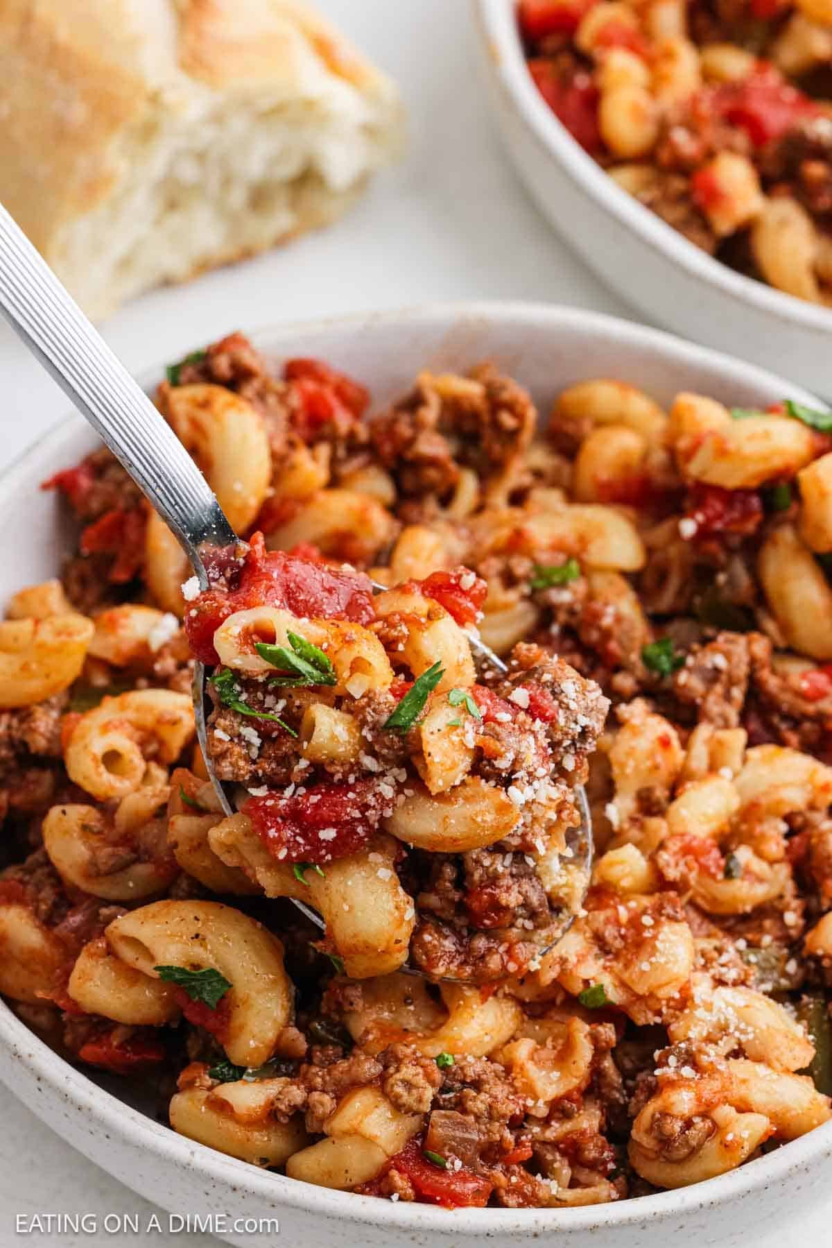 A serving of the recipe in a bowl with a bite on a spoon.